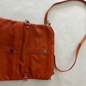 A soft orange leather clutch with shoulder strap.  Soft Leather like butter!
